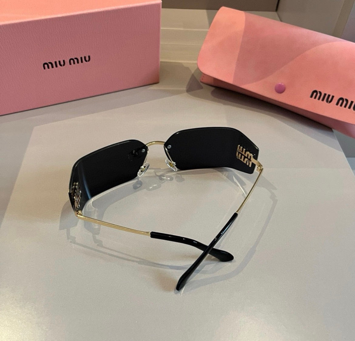 Miu Miu SMUA54 Black Rimless Oval Sunglasses