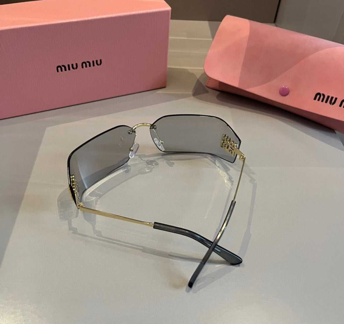 Miu Miu SMUA54 Clear Rimless Oval Sunglasses